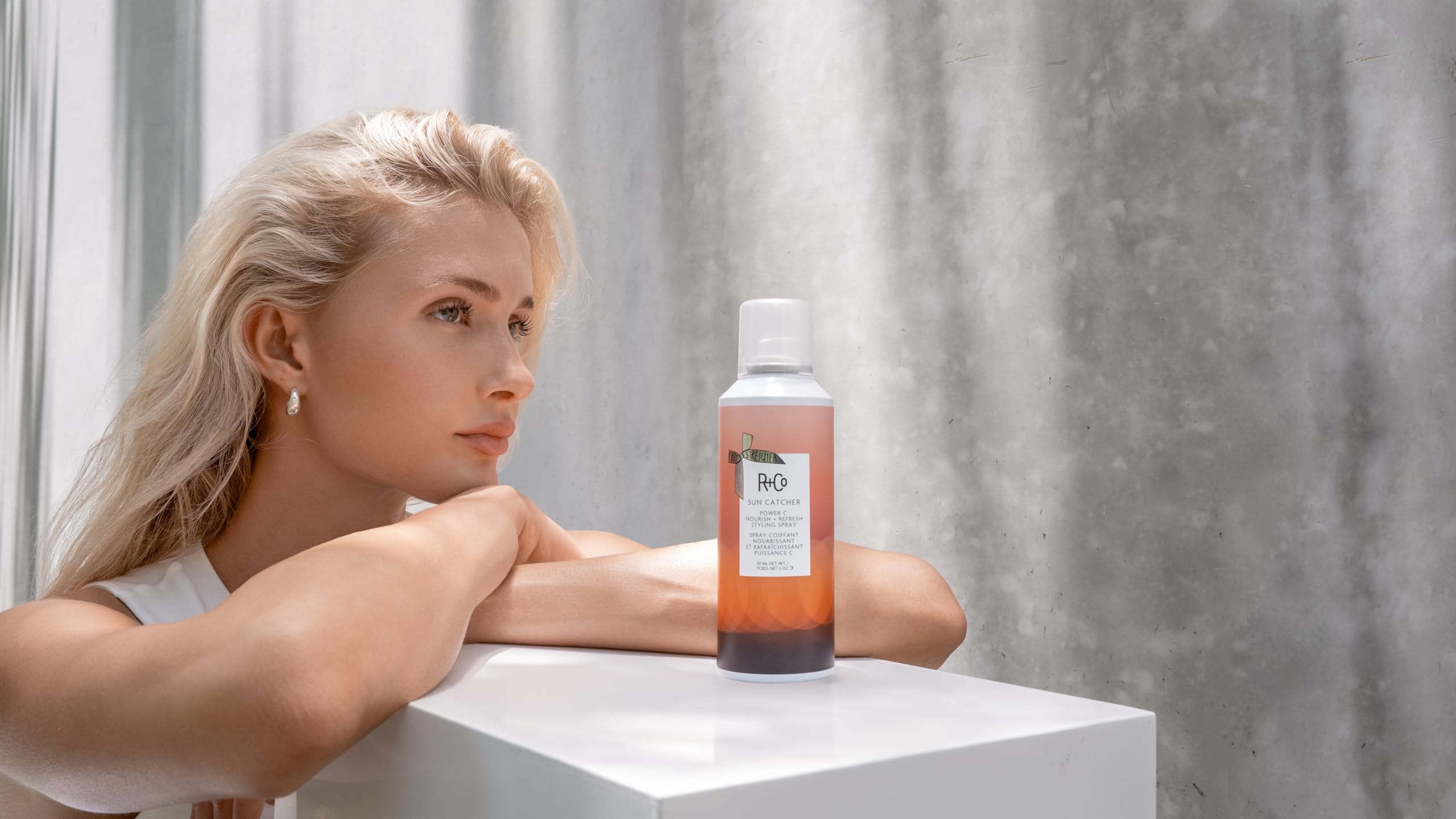 R+Co SUN CATCHER mist delivering hydrated shine for air-dried hair.