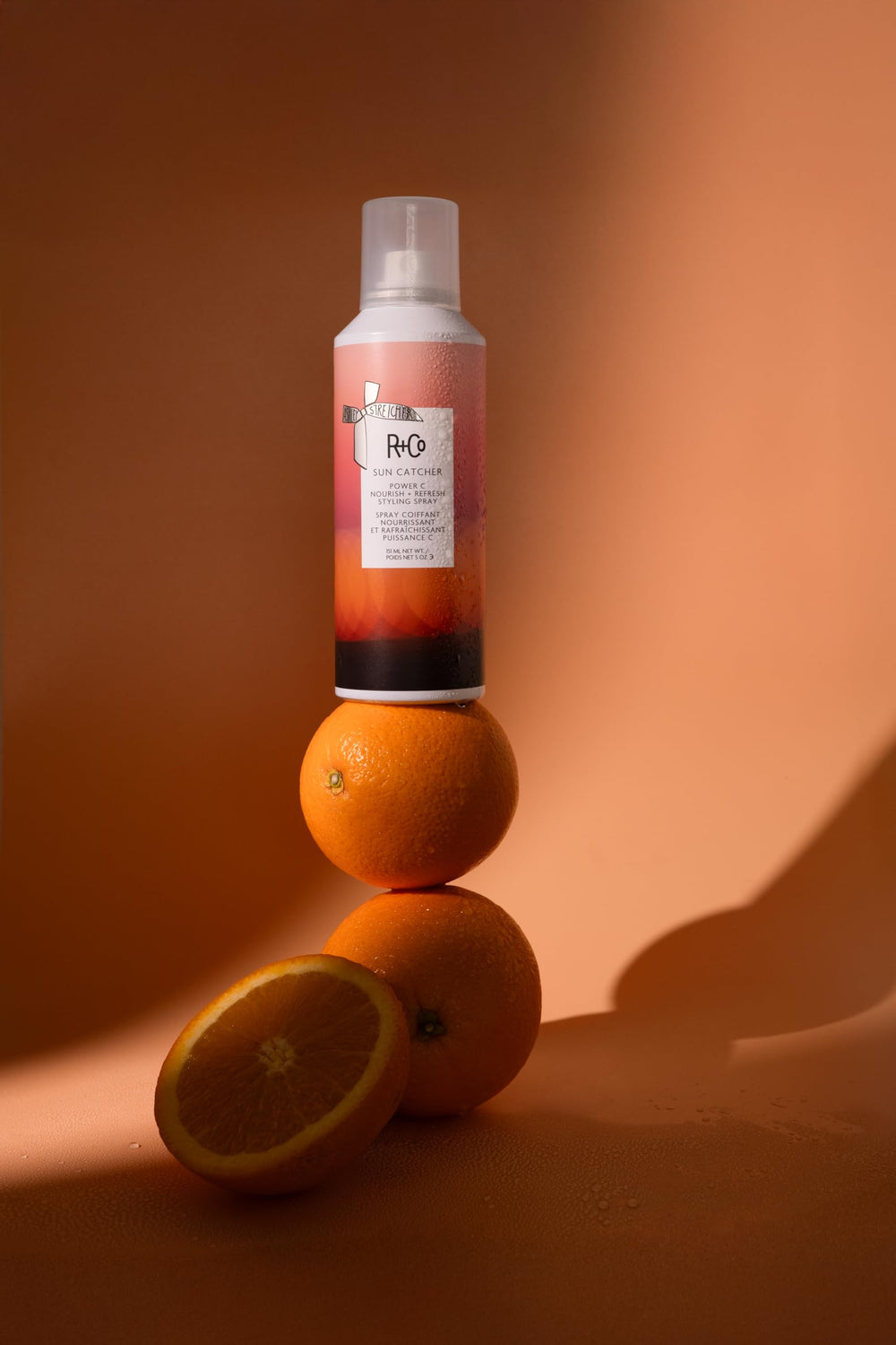R+Co SUN CATCHER spray mist delivering lightweight hydration and frizz control.