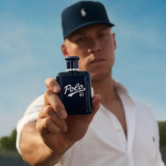 Polo 67 box and bottle on clean surface conveying vibrant citrus mood.