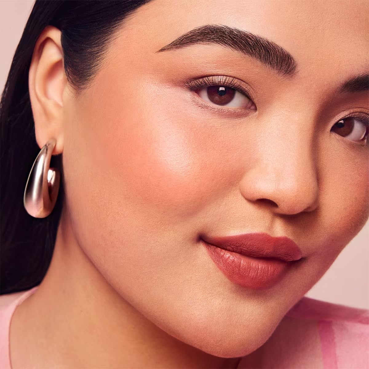 Rare Beauty Beloved mini blush close-up, a muted oxblood shade for versatile everyday color.