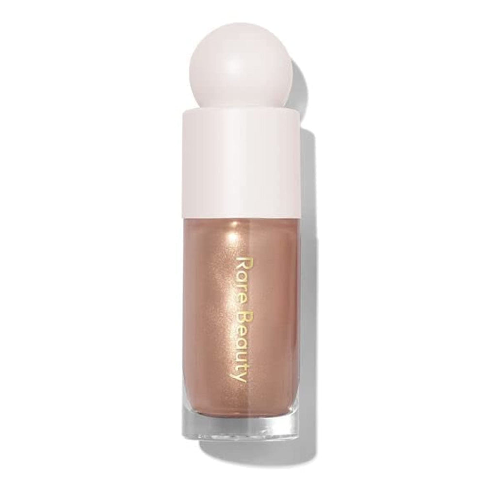 Rare Beauty Positive Light Luminizer Transcend bottle close-up showing luminous glow for instant radiance
