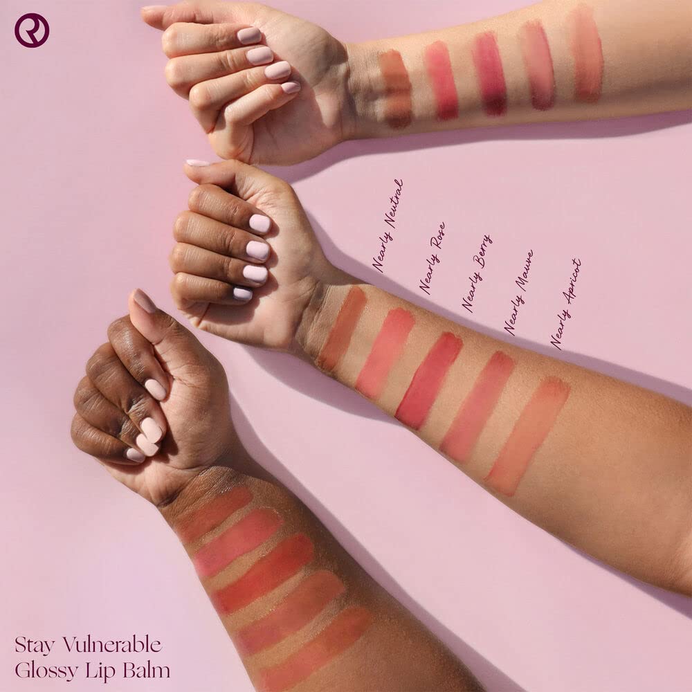 Close-up of Rare Beauty Stay Vulnerable lip balm in nearly mauve providing soft shine and cushion.
