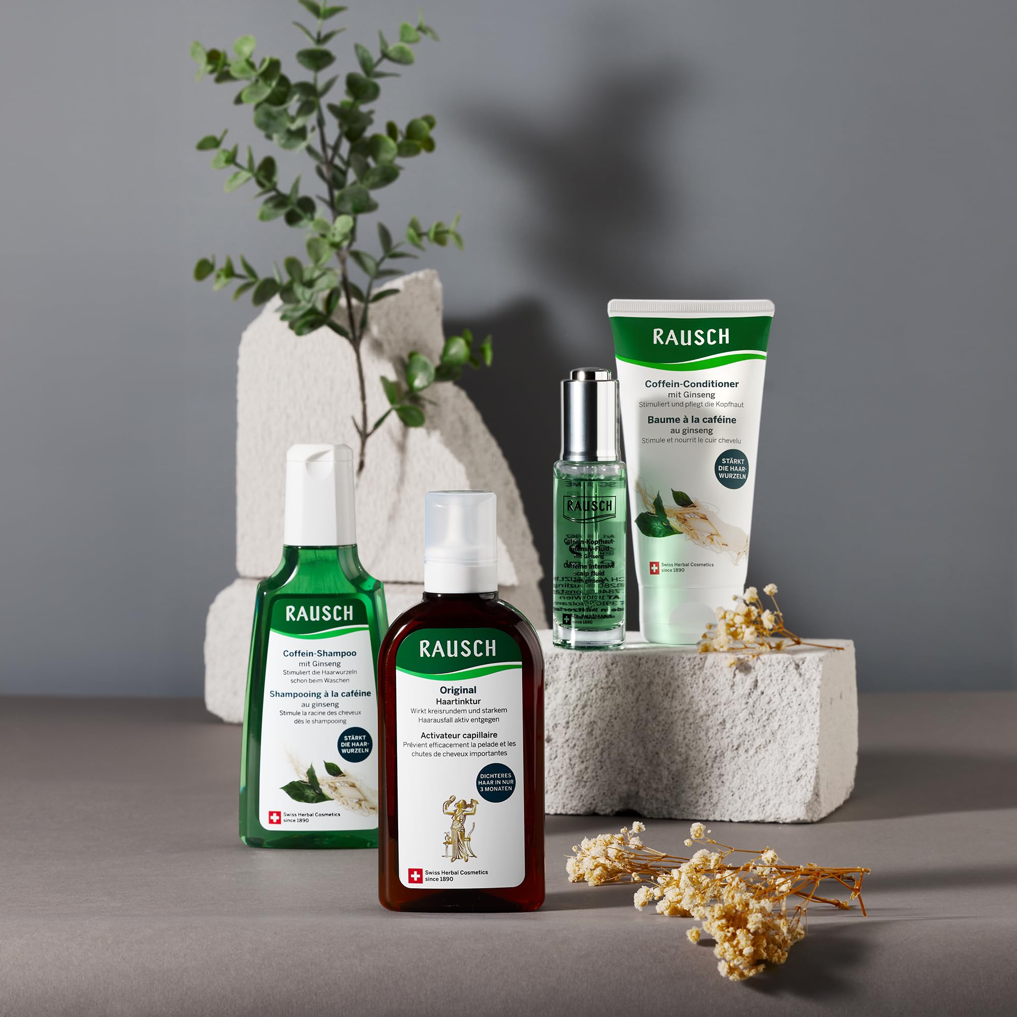 RAUSCH bottle on stone surface conveys premium care.