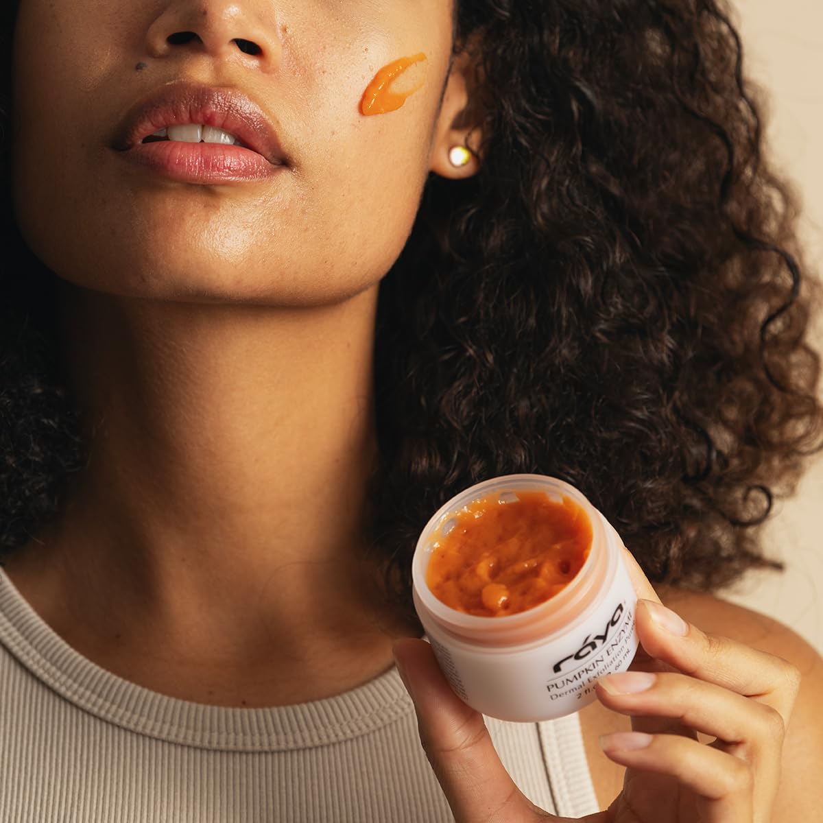 Raya Pumpkin Enzyme Facial Puree on face with a radiant glow.