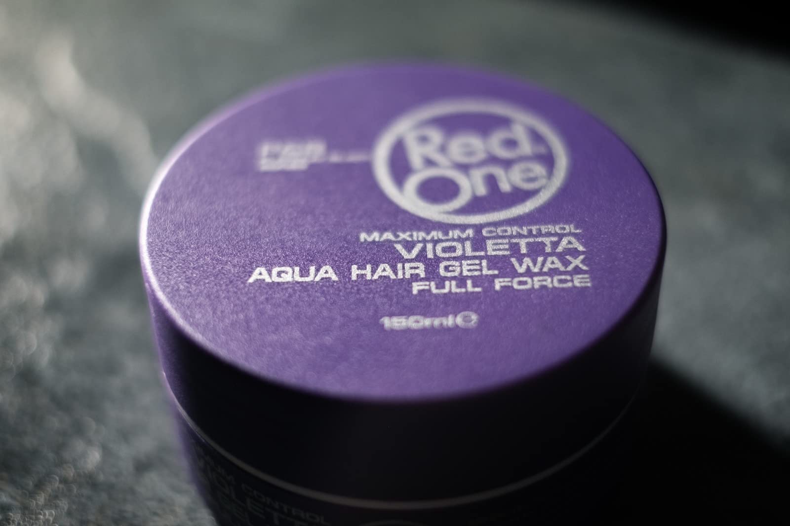 Product pack display of RedOne Aqua Hair Wax in violet packaging
