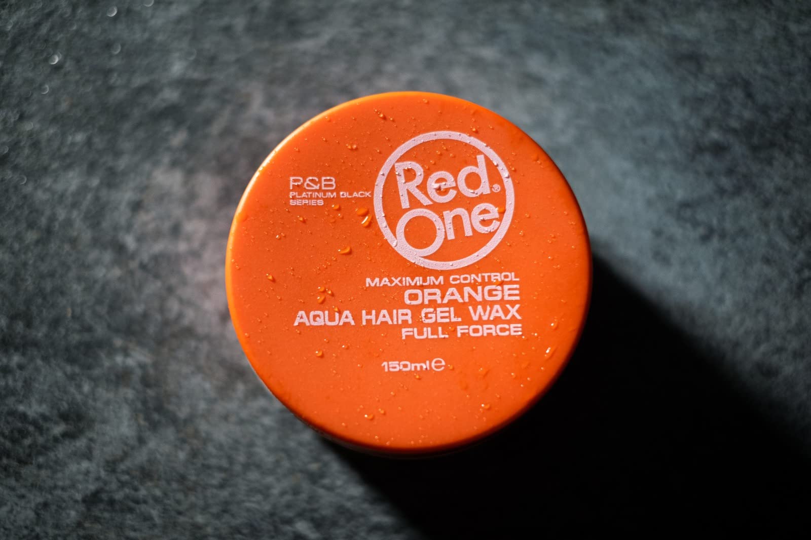 Redone Hair Wax Orange glossy hair under bright light highlights salon-quality shine