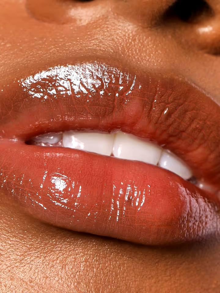 REFY Lip Gloss Dusk texture close-up highlights rich mahogany pink color.