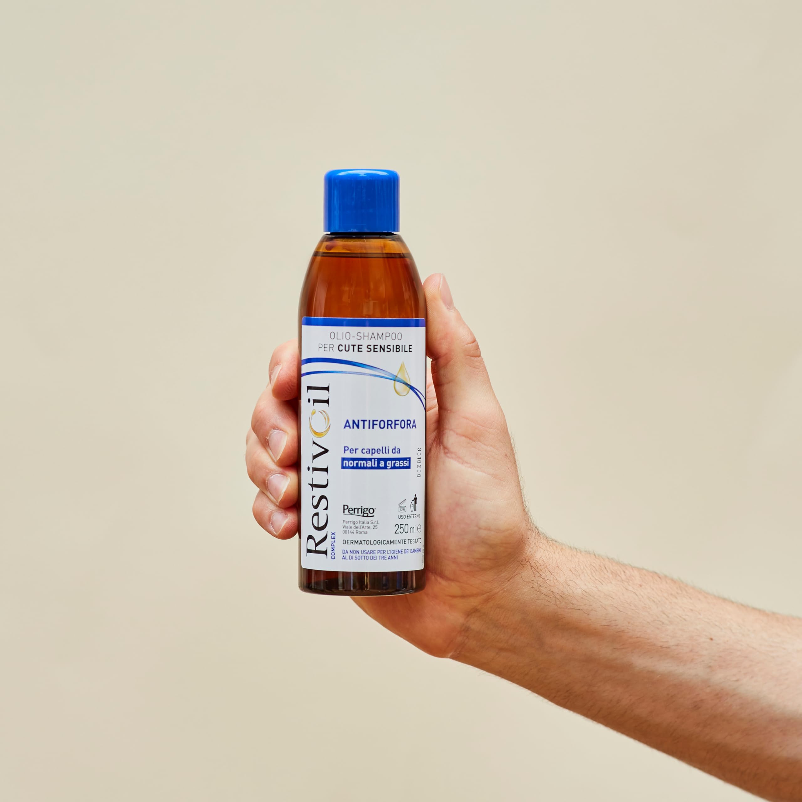 RestivOil bottle beside towel hints at refreshed scalp after wash.