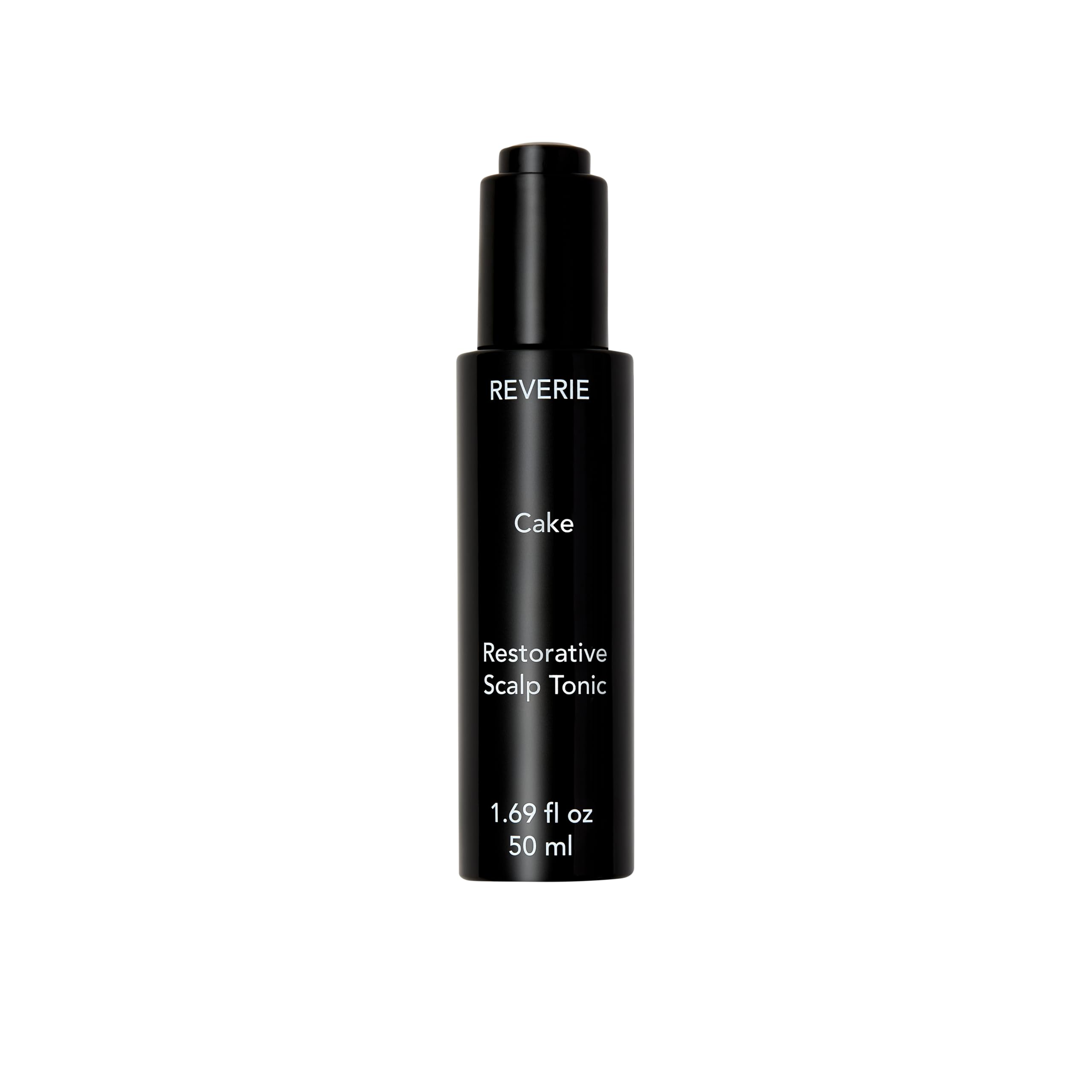 REVERIE Cake Restorative Scalp Tonic bottle pour showing soothing hydration for dry scalps