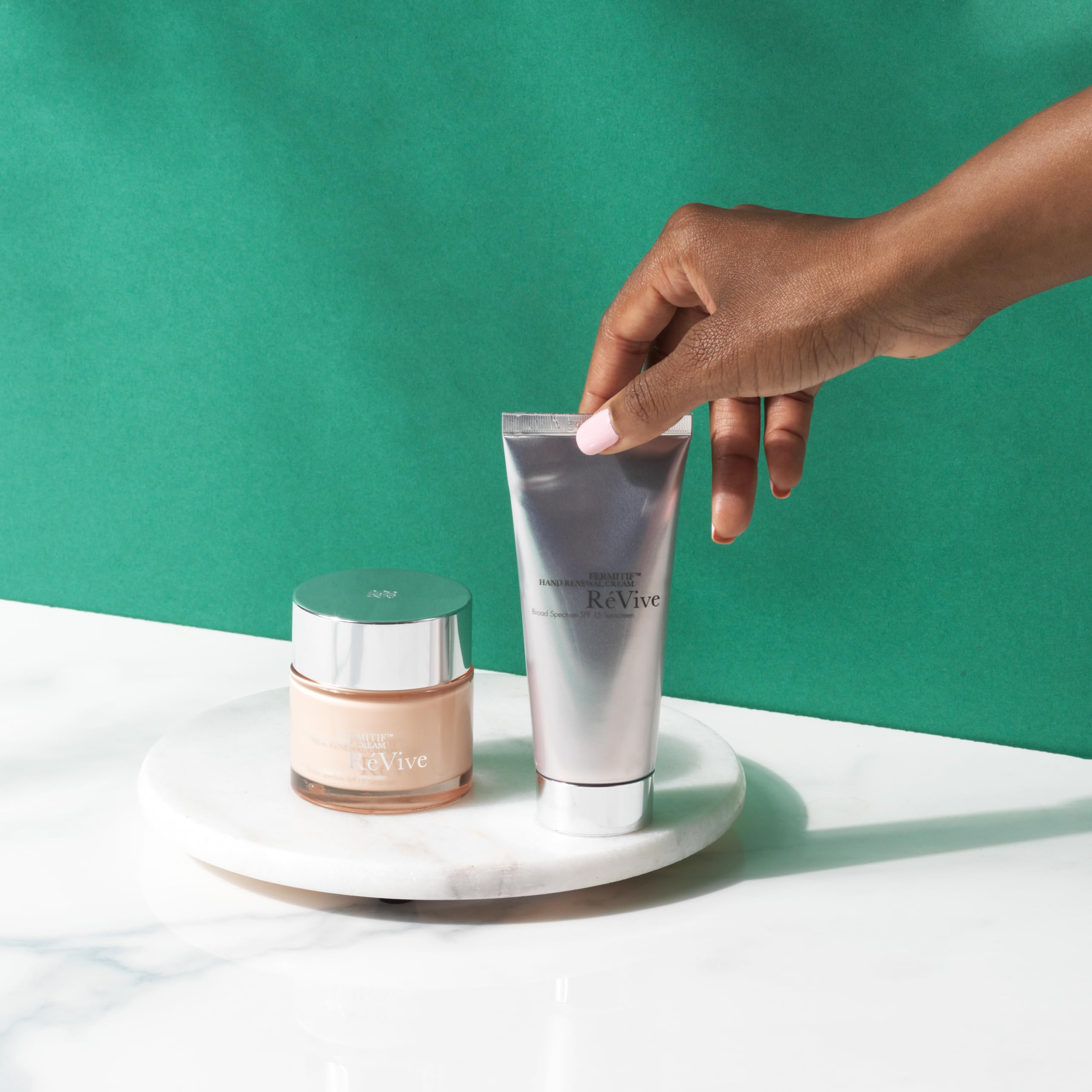 RéVive hands applying cream to cuticles for daily nourishment