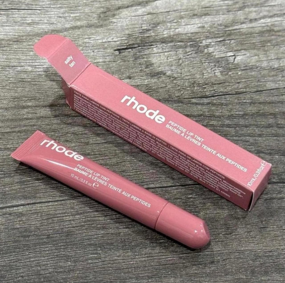 Rhode Peptide Lip Tint Salty Tan being applied for a hydrated glossy lip.