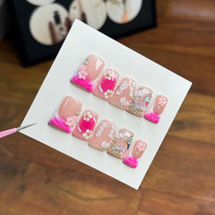 RIICFDD nails with butterfly rhinestones on rose pink for elegant events