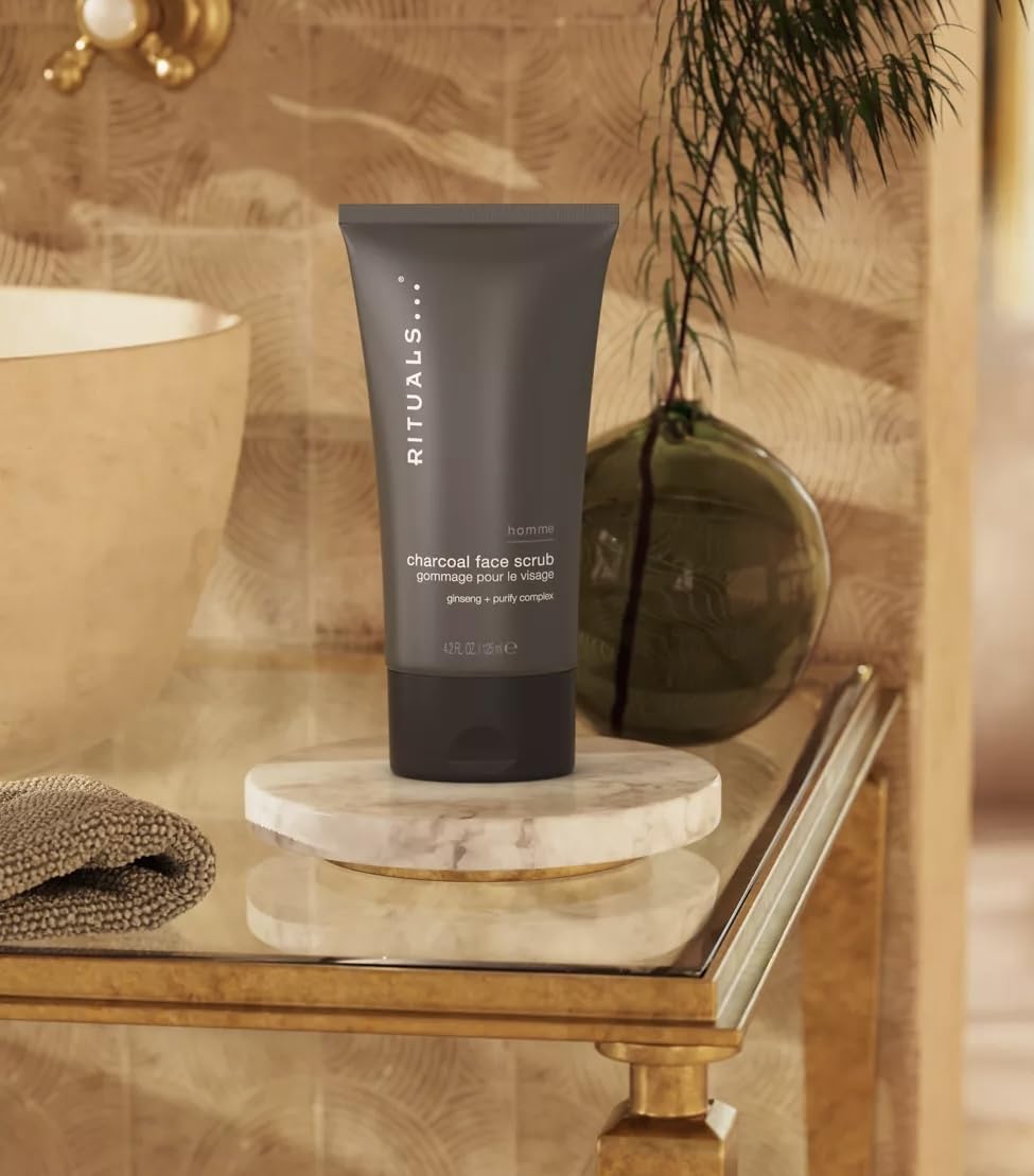 Lather forming in hand with RITUALS Homme Charcoal Face Scrub for refreshing exfoliation.