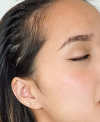 River Organics vegan blush stick applied to eyelids for cohesive daytime look