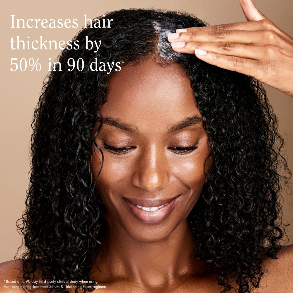 Rizos Curls Thickening Foam applying to roots to lift hair