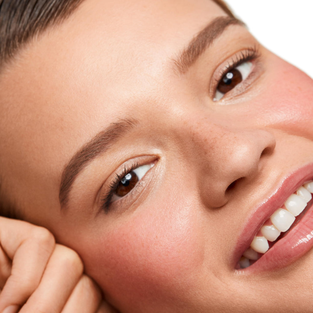 Applied on apples of cheeks for a natural glow with Saie Dew Blush.