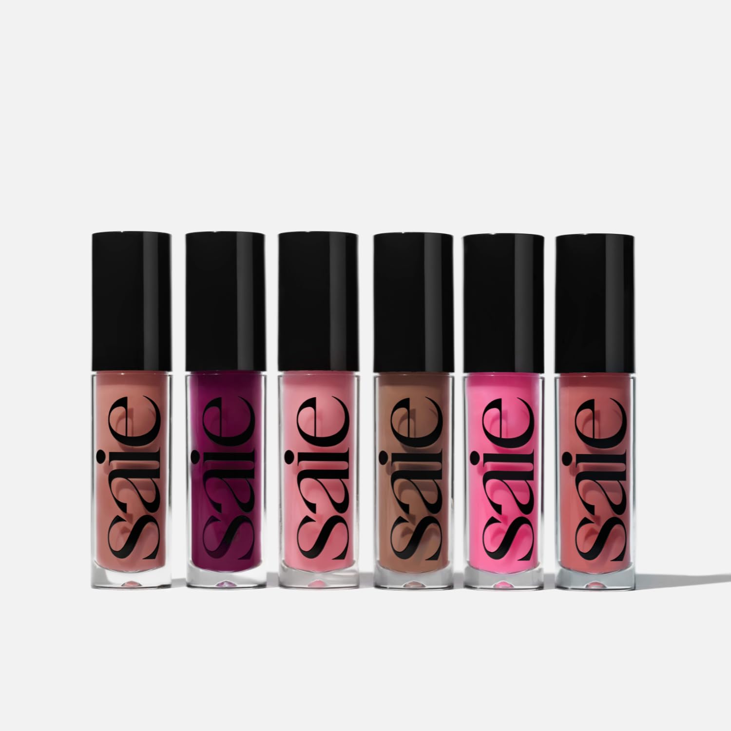 Saie Glossybounce glossy finish on lips conveys vibrant shine.