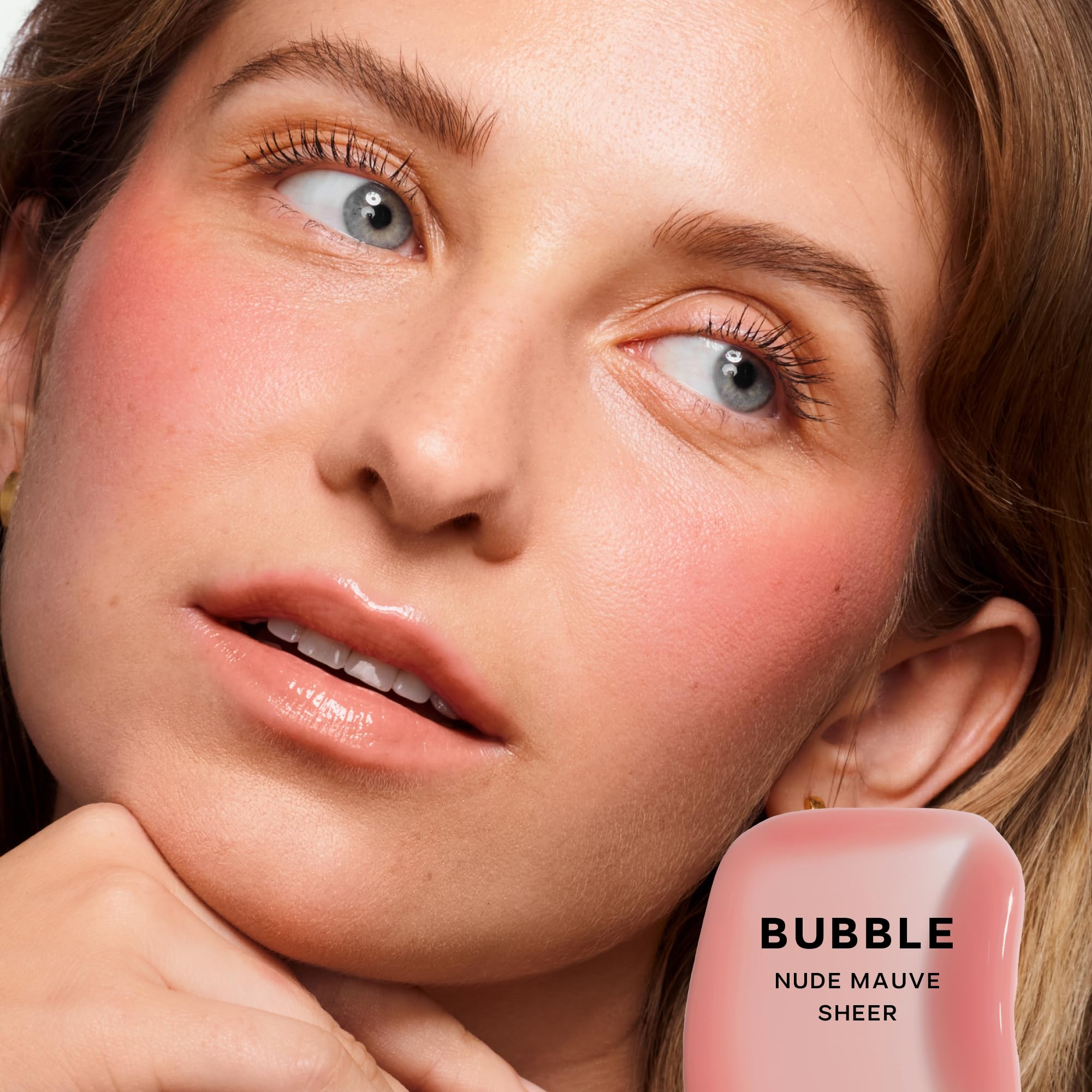 Saie Glossybounce swatch shows sheer, lip-enhancing color with glassy shine.