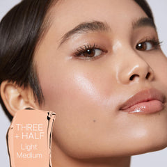 Saie Slip Tint SPF 35 swirl on cheek demonstrates light coverage and dewy glow