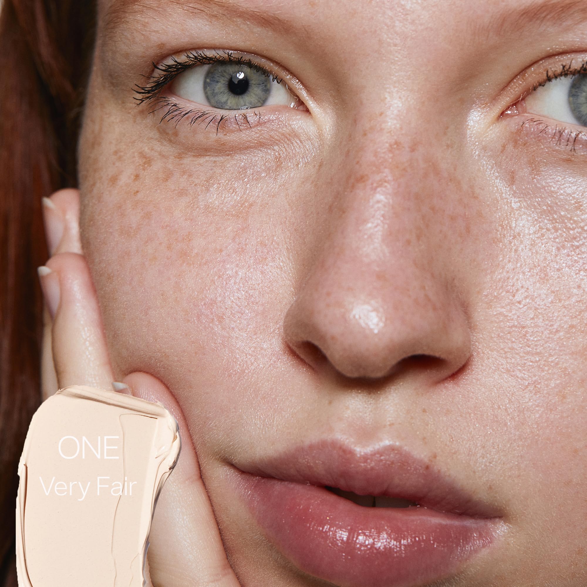 Saie Slip Tint swatch forearm reveals sheer coverage with pink undertones.