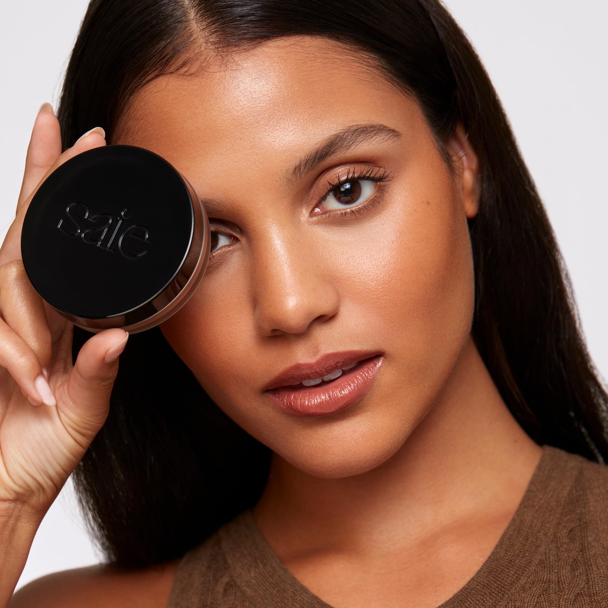 Saie Sun Melt bronzer on temples and forehead for balanced warmth