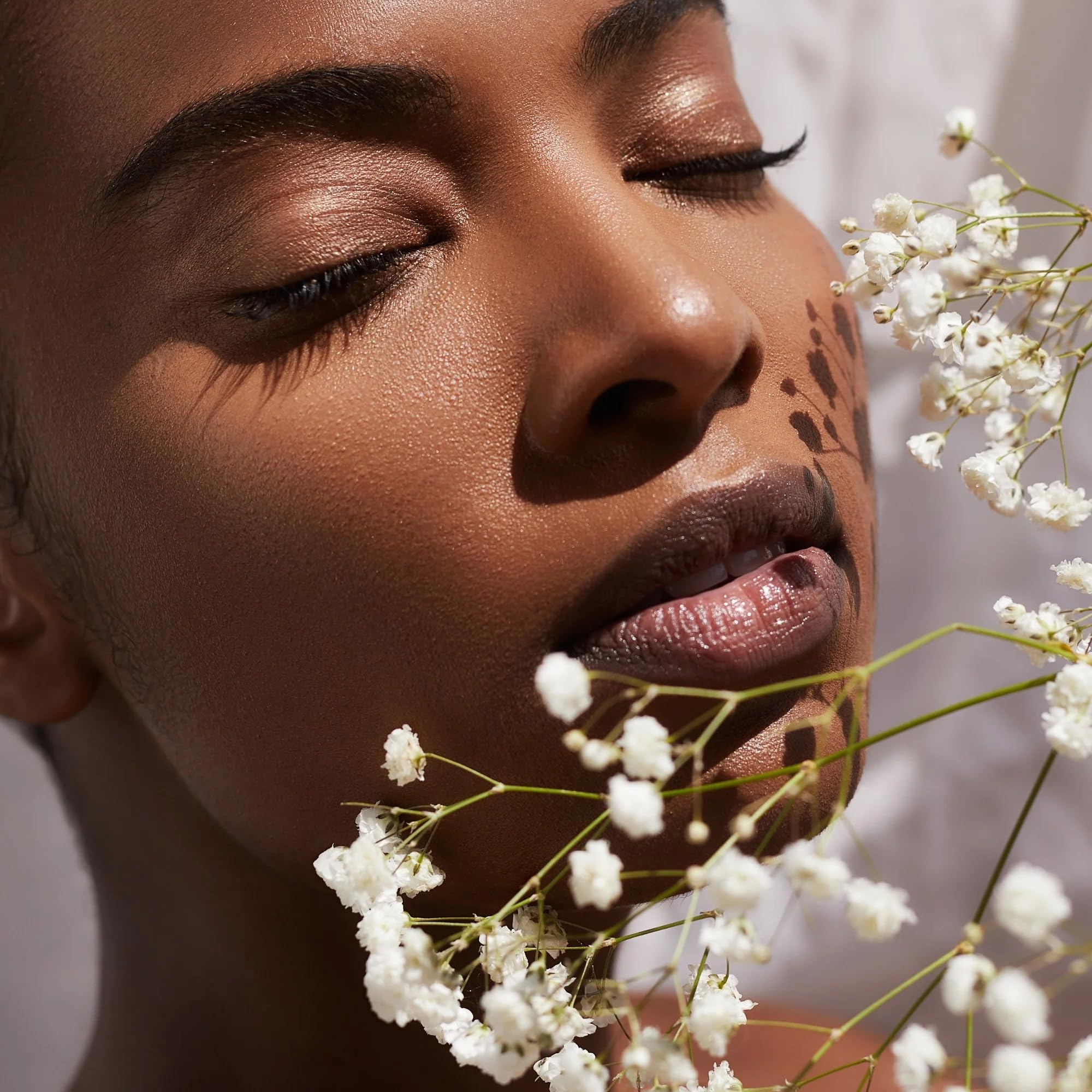 SAINT JANE Nectar lip oil scene with florals for luxury skincare vibe