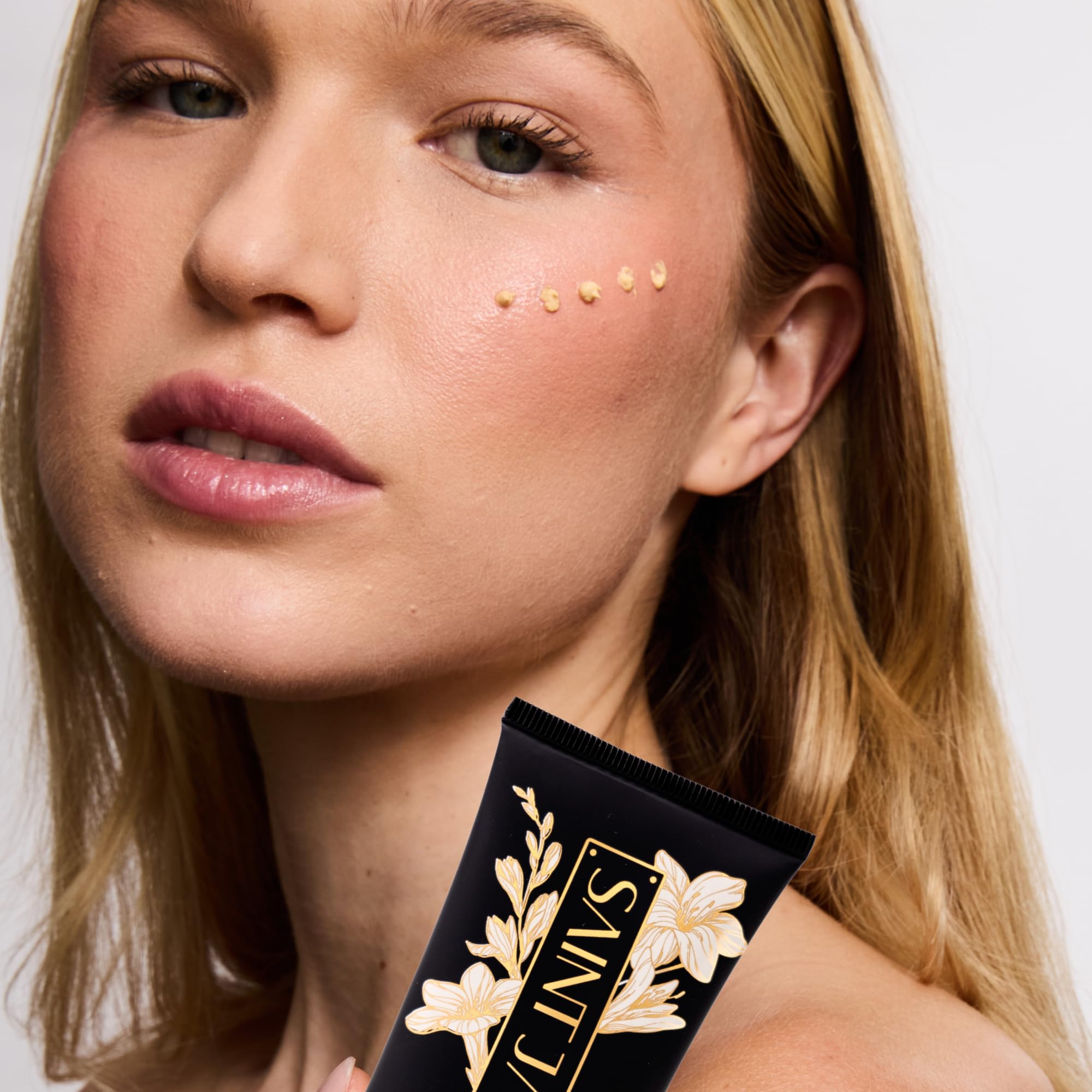 SAINT JANE Luxury Sun Ritual bottle on vanity, a luxe floral sun care ritual
