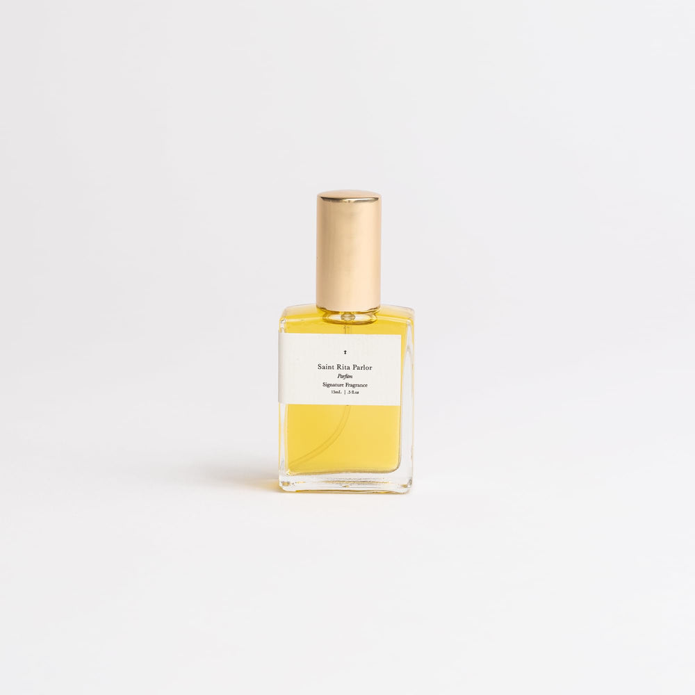 Saint Rita Parlor Signature Parfum bottle highlighting whiskey tones for warm, inviting moments.
