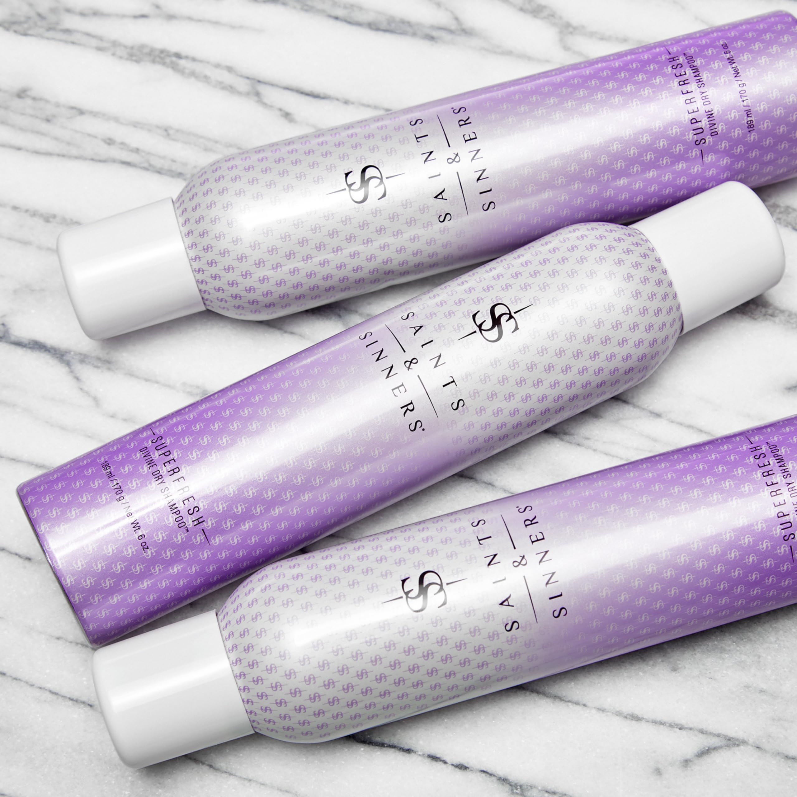 Saints & Sinners Superfresh Divine dry shampoo applying to hair for quick uplift.