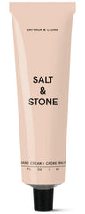 Salt and Stone hand cream bottle with saffron and cedar scent for daily hydration.