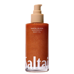 Saltair Shimmering Body Oil bottle gleaming with light-reflecting shimmer.