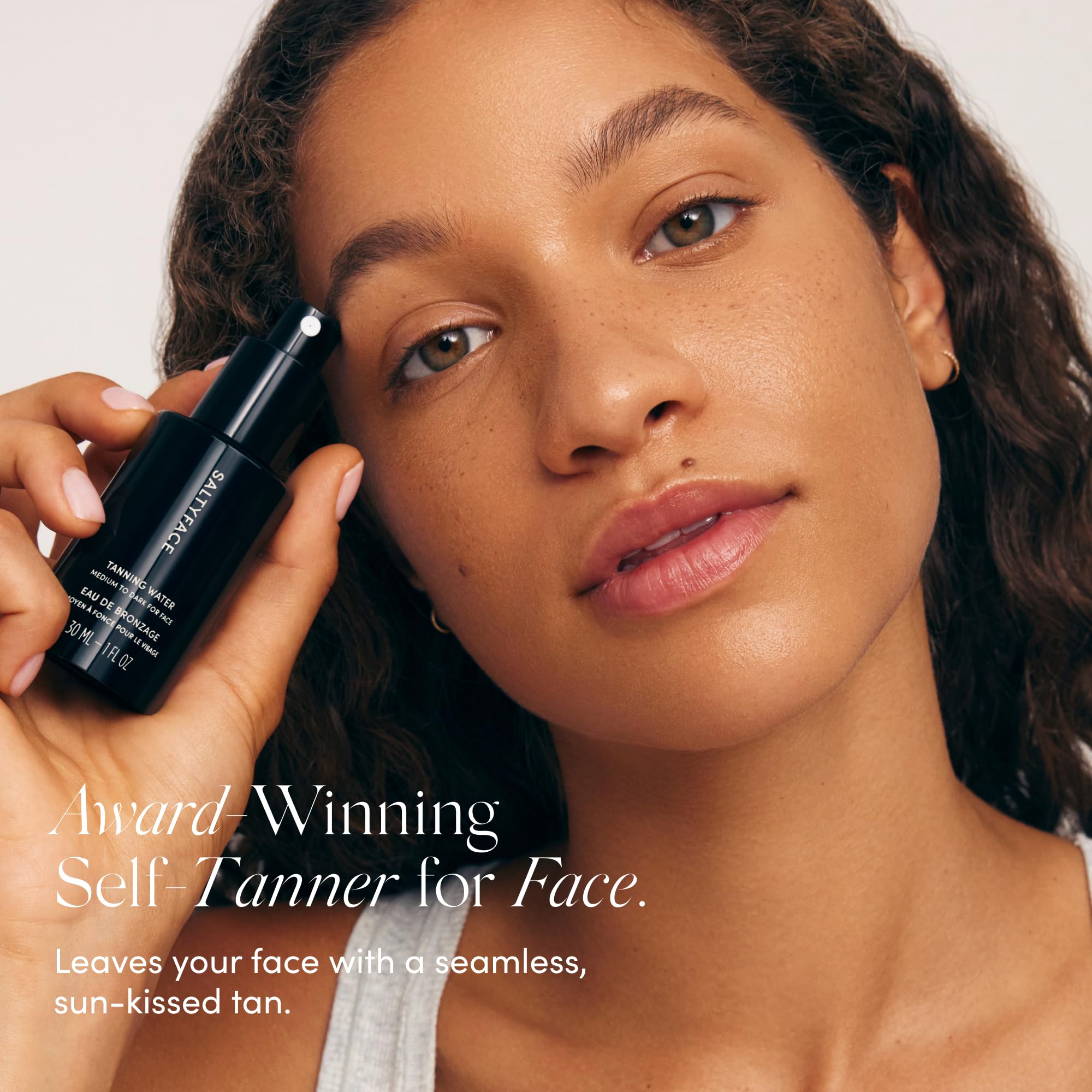 SALTYFACE Tanning Water face-application shows precise, even coverage for a natural glow.