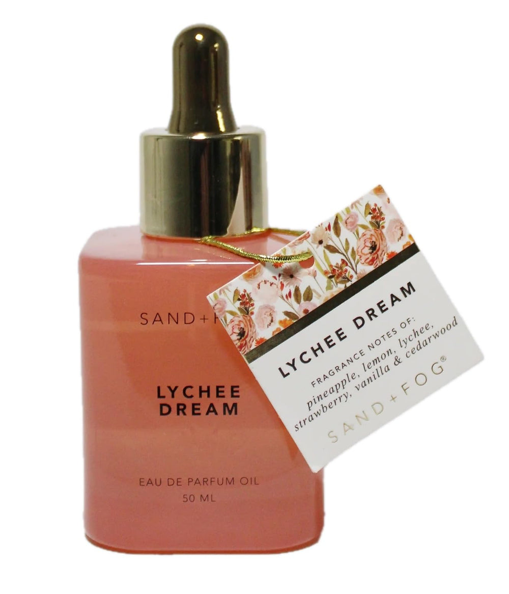 Sand + Fog Lychee Dream bottle close-up with premium coral glass for daily wear.