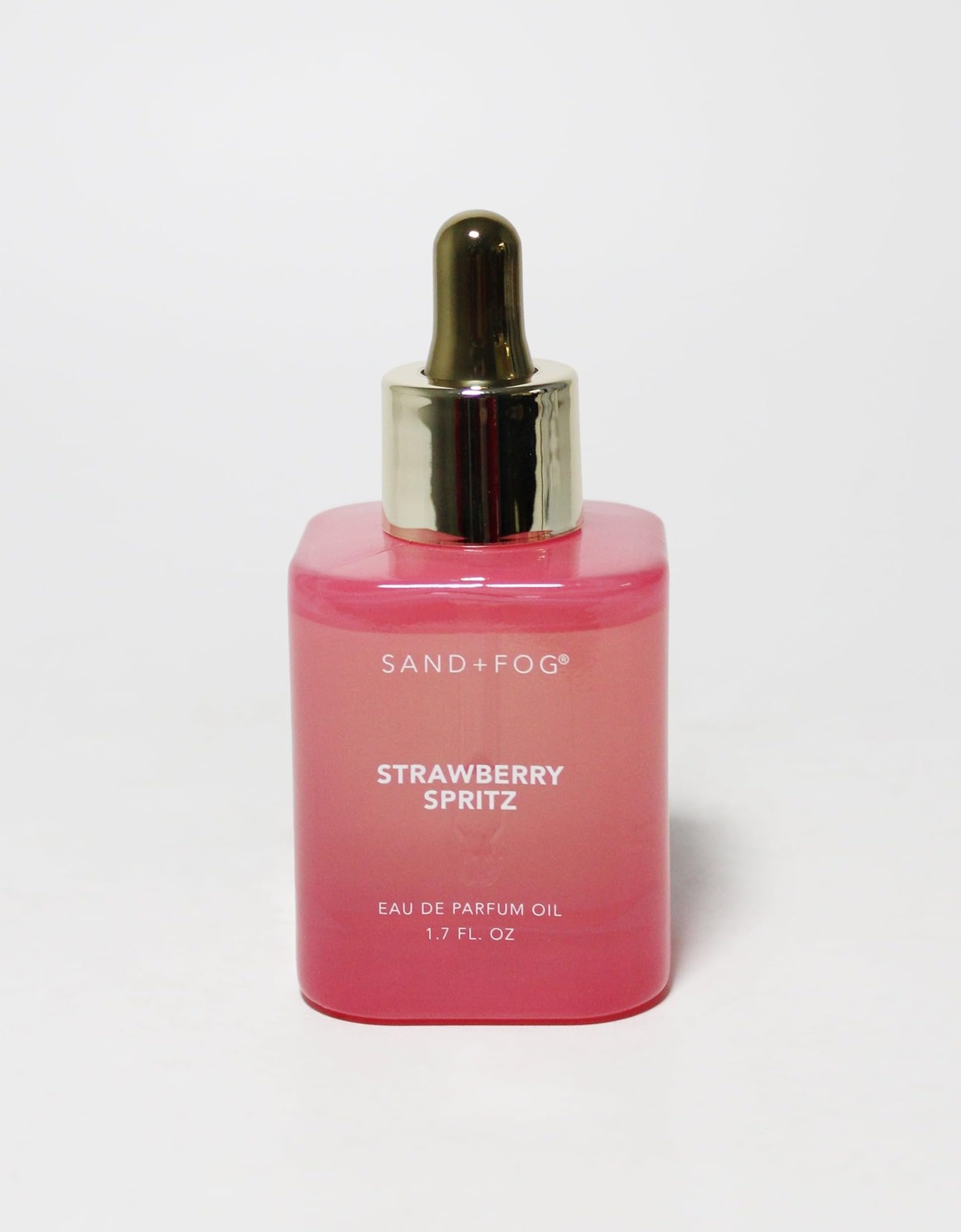 Sand + Fog Strawberry Spritz bottle on a clean surface, showcasing a vibrant, long-lasting fragrance.