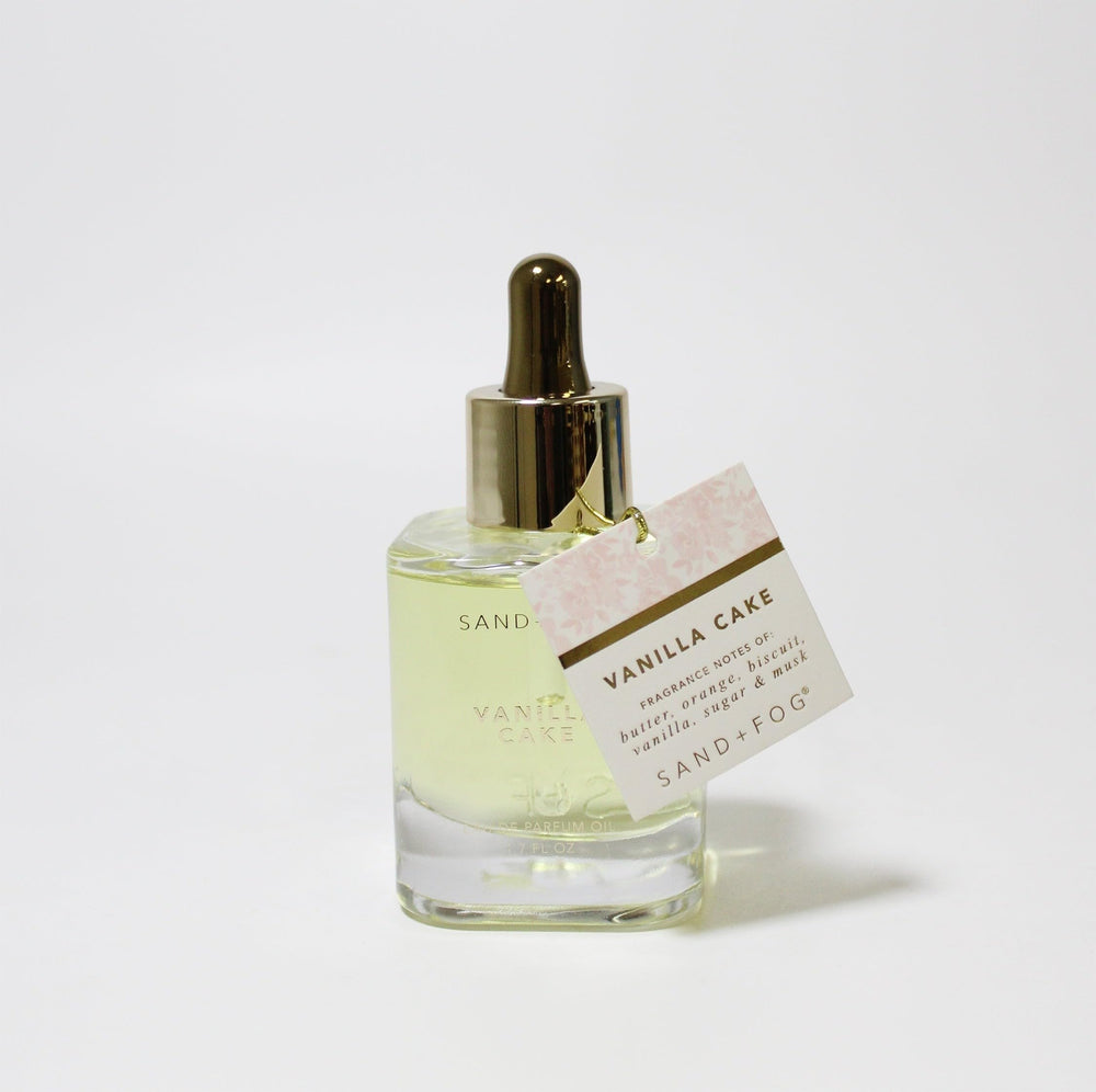 Close-up of Sand + Fog Vanilla Cake Parfum Oil dropper for targeted application.