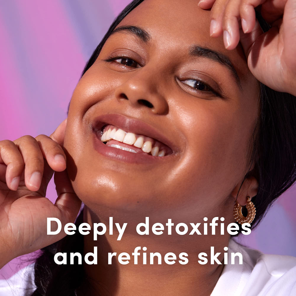 Application shot of Sand and Sky Pink Clay Cleanser being applied to the face.