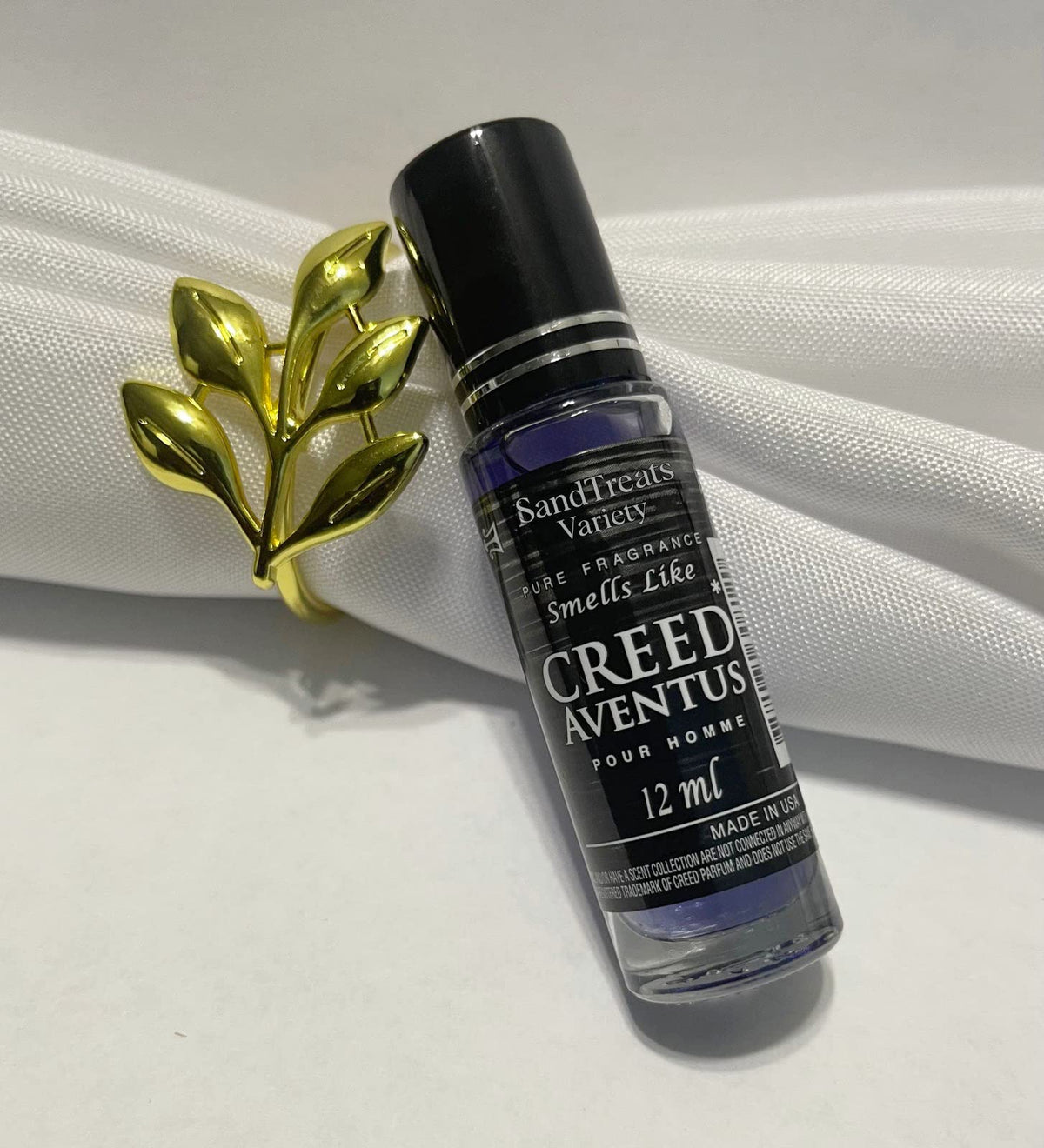 SandTreatsVariety Creed Aventus roll-on bottle for on-the-go fragrance.