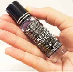 SandTreatsVariety Creed Aventus roll-on cap for precise, mess-free application.