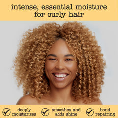Hands applying SAUCE conditioner for smooth, detangled curls