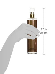 Applying Sean John Unforgivable body mist for even fragrance application.