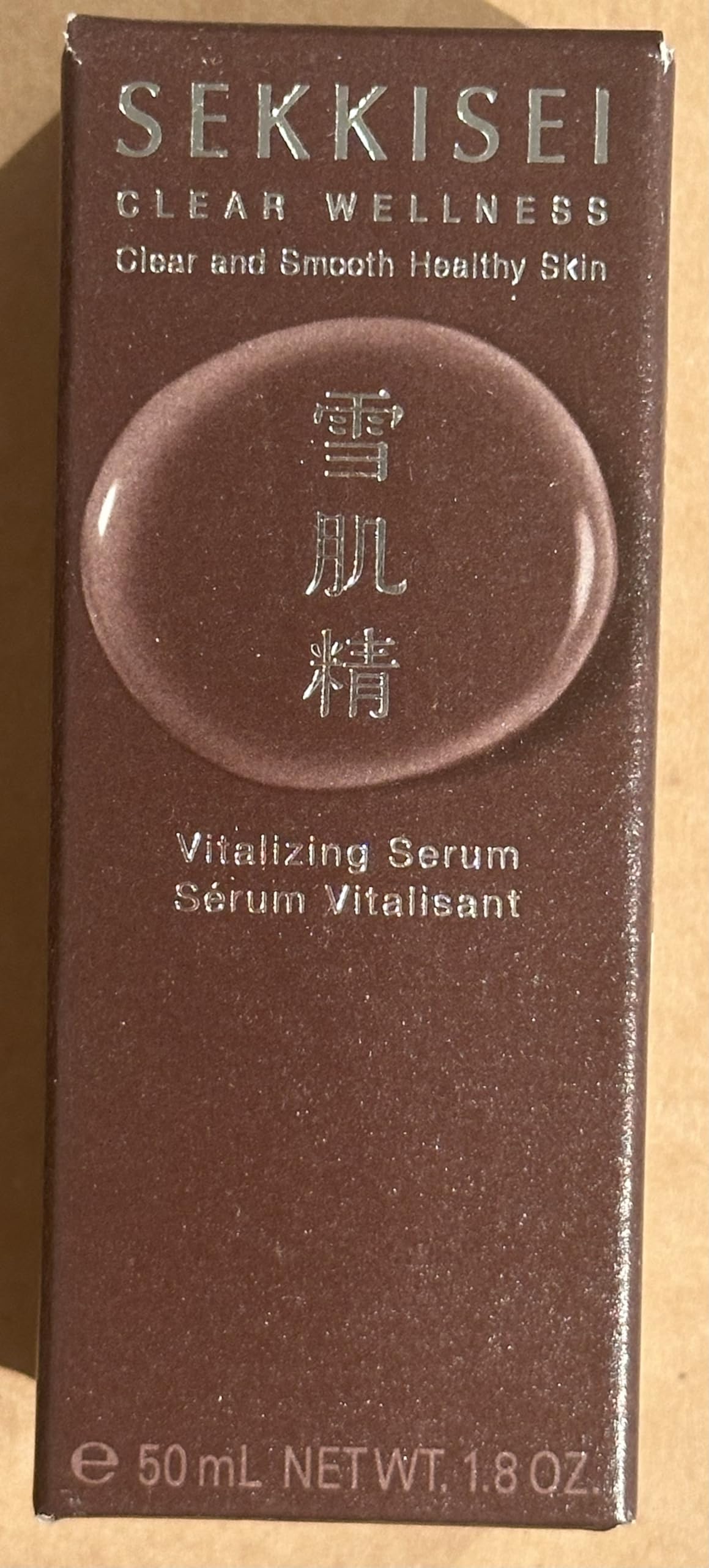 SEKKISEI Clear Wellness Serum applying to cheek for dewy finish.