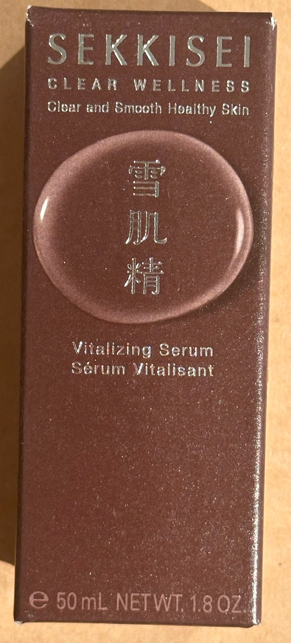 SEKKISEI Clear Wellness Serum applying to cheek for dewy finish.