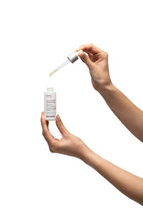 Sensilis D-Pigment Serum ATX B3 serum drop on finger for precise application.