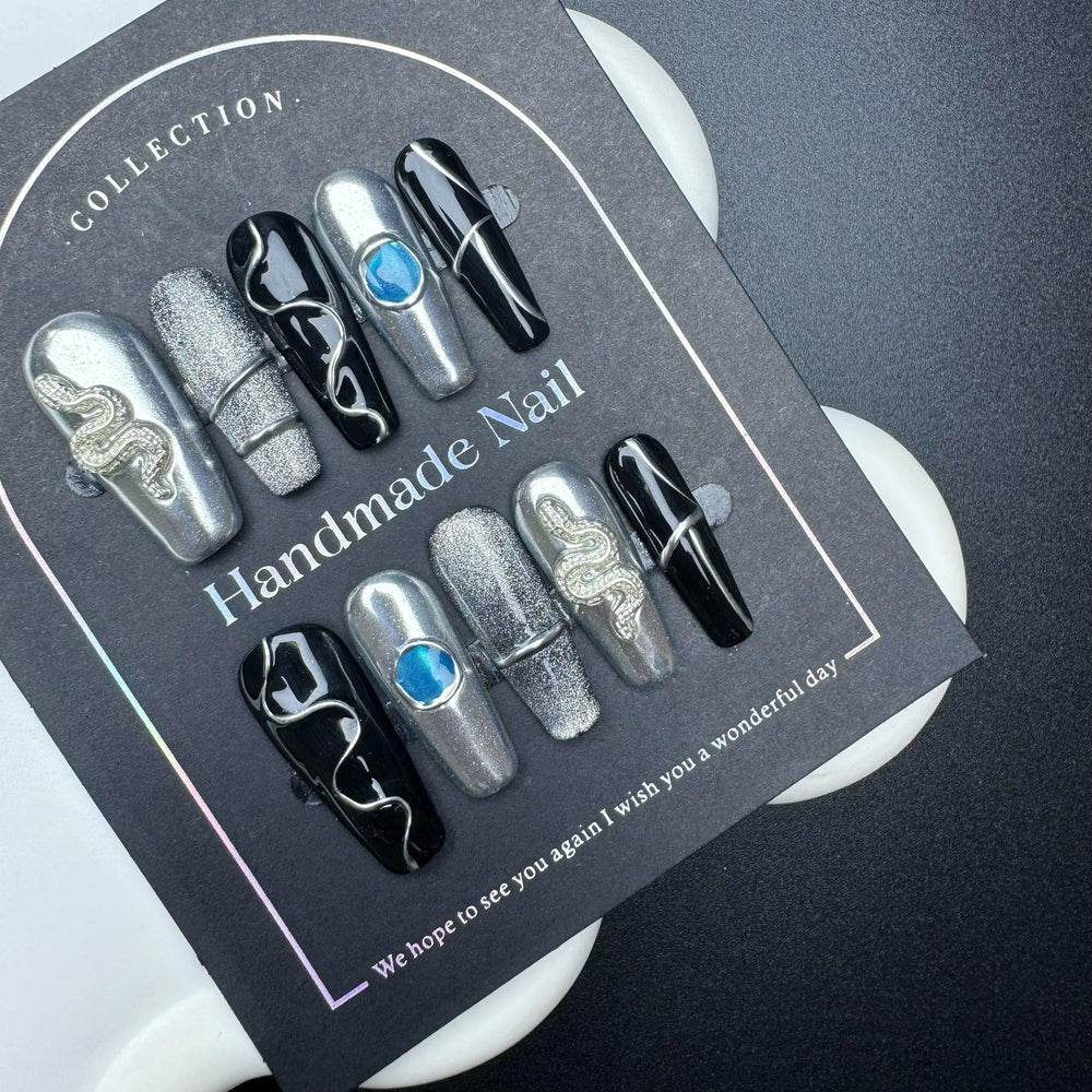 Sevgob 5D embossed nails with snake charms for quick at-home nail art.