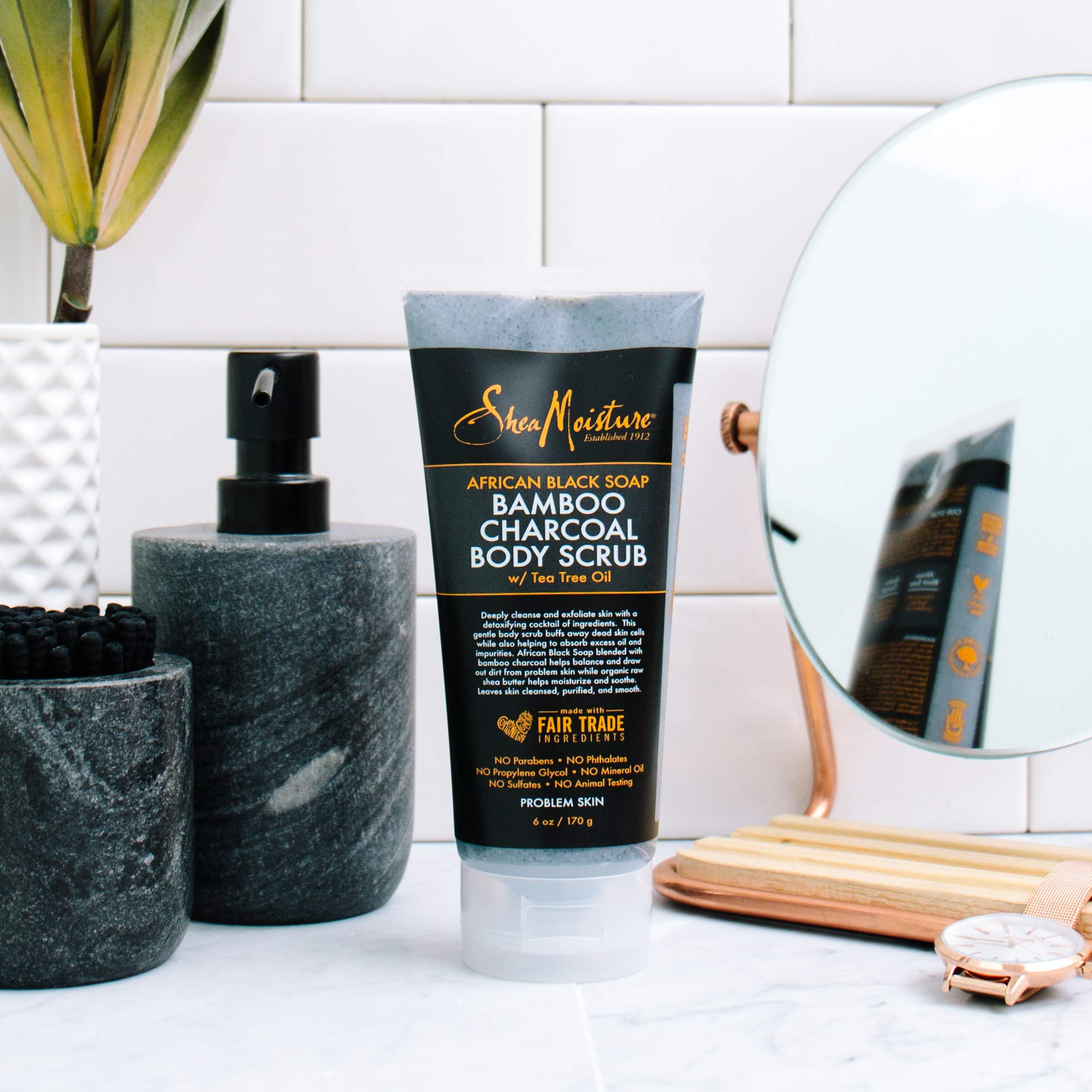 SheaMoisture African Black Soap Bamboo Charcoal body scrub on bath shelf