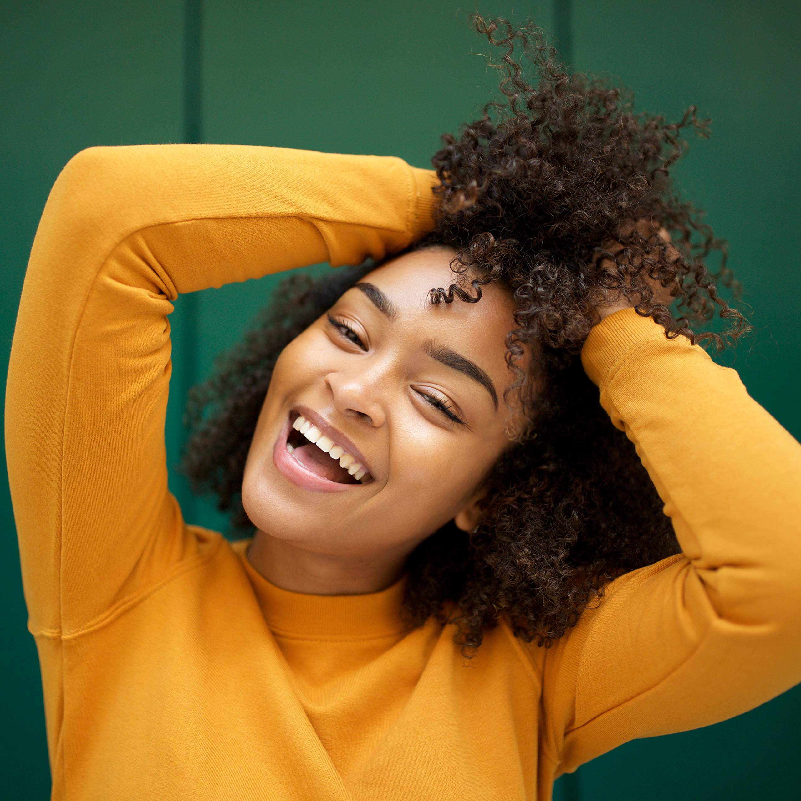 Dispensing SheaMoisture conditioner to palm for easy use.