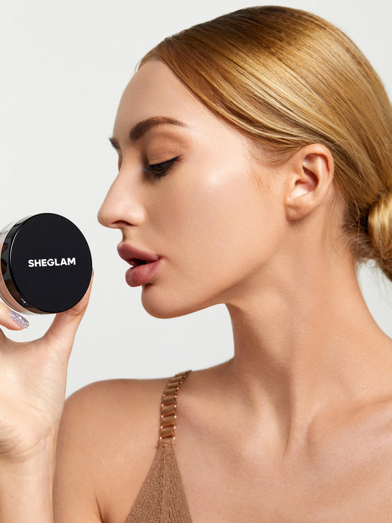 SHEGLAM Baked Glow powder in light pink shade on skin for natural glow.