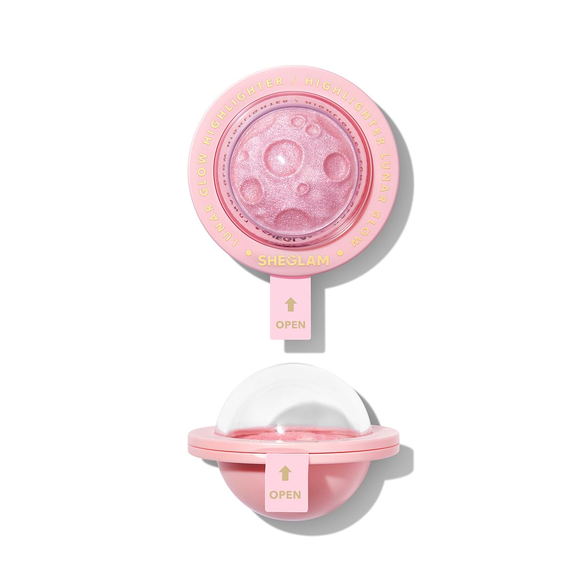 SHEGLAM Lunar Glow Highlighter on heart-galaxy pattern for radiant facial glow.