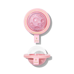 SHEGLAM Lunar Glow Highlighter on heart-galaxy pattern for radiant facial glow.