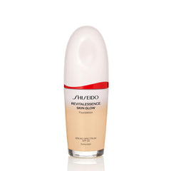 Shiseido RevitalEssence Glow Foundation bottle showing radiant finish on skin.